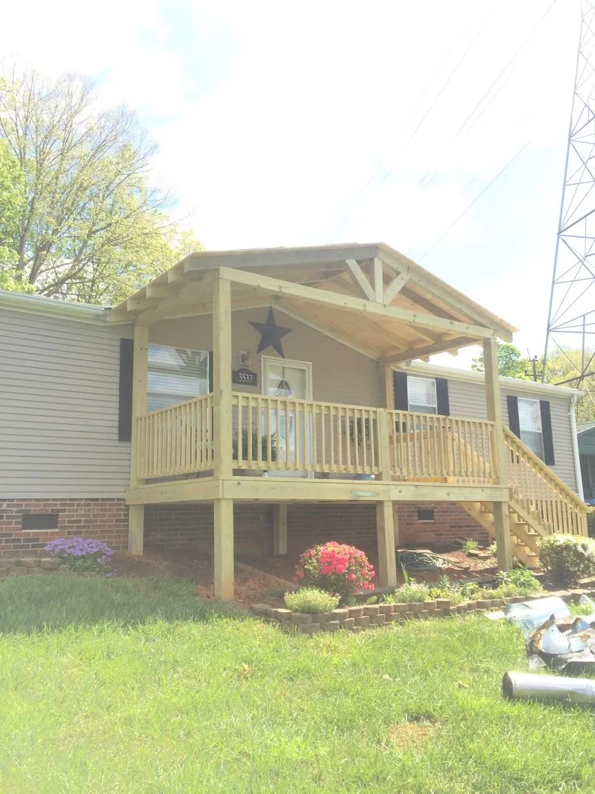 New gabled porch roof and deck railing added to a ranch home in Southfield